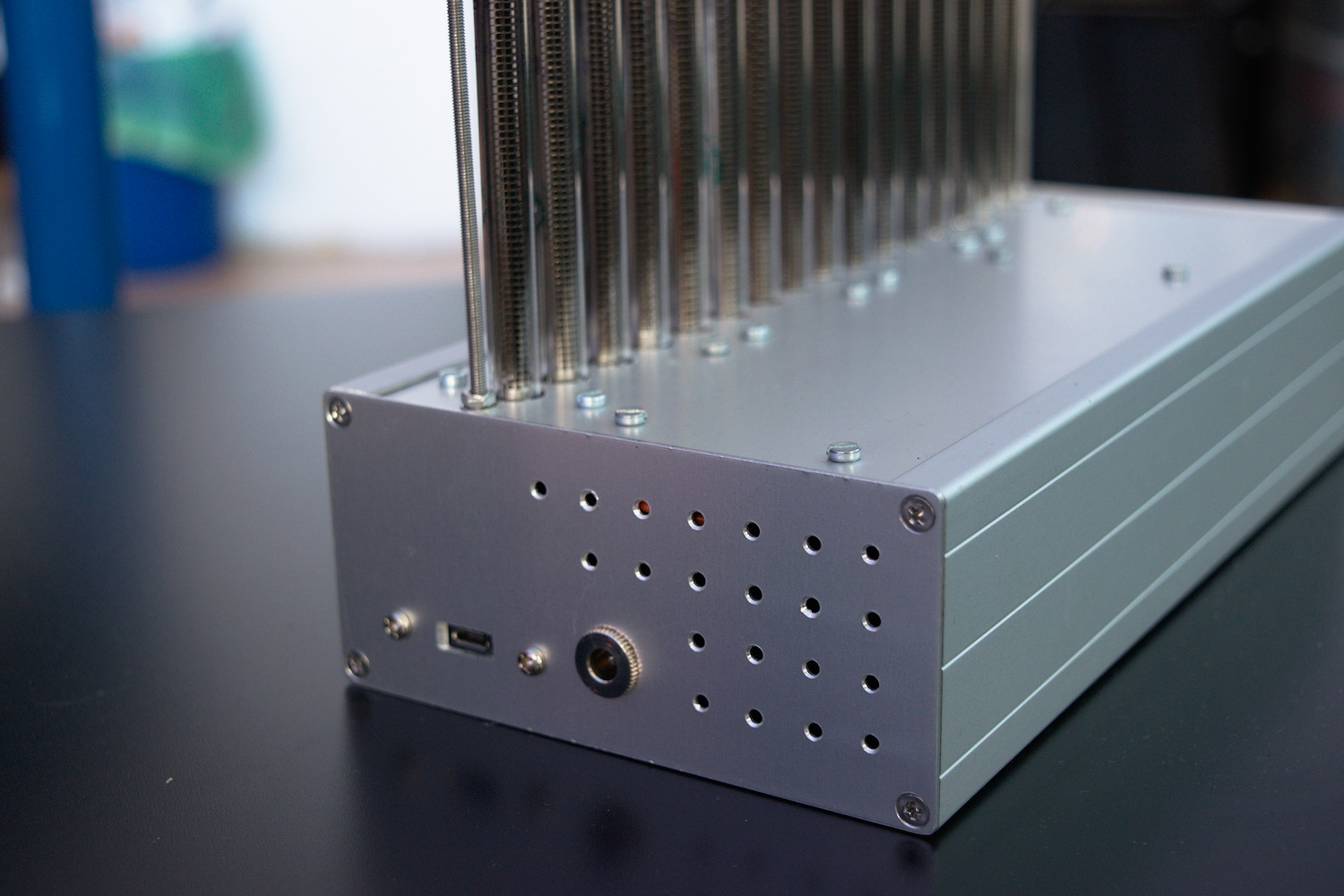 The same aluminum case, but the device is switched off. On the side of the case, there is a round power input, ventilation holes and a USB port